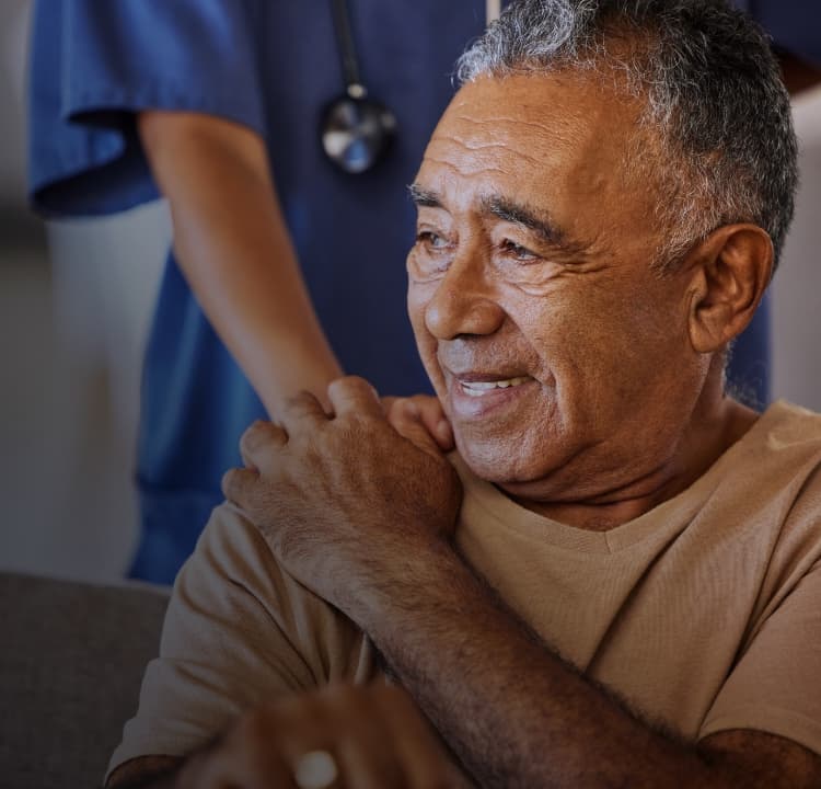 Doctor with hand on man's shoulder