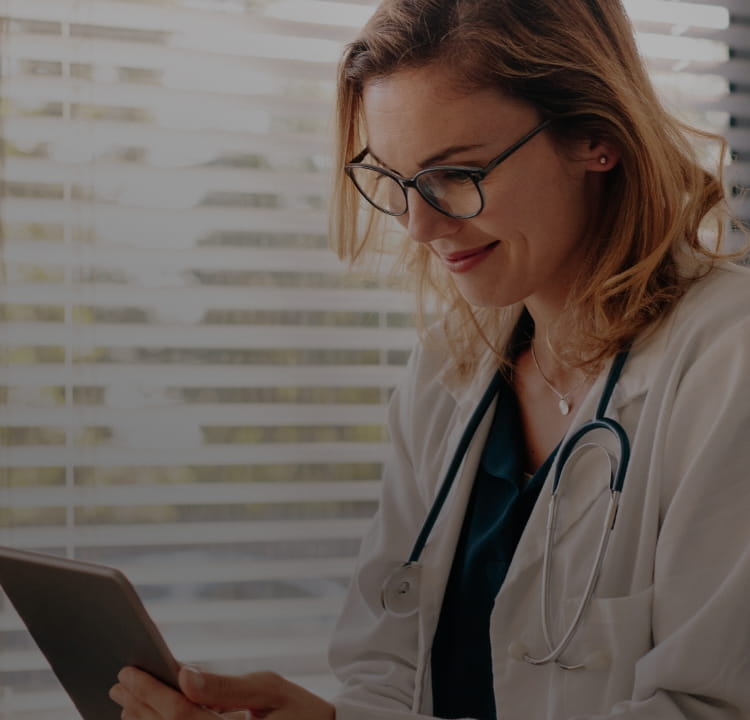Doctor reading off a tablet in her office